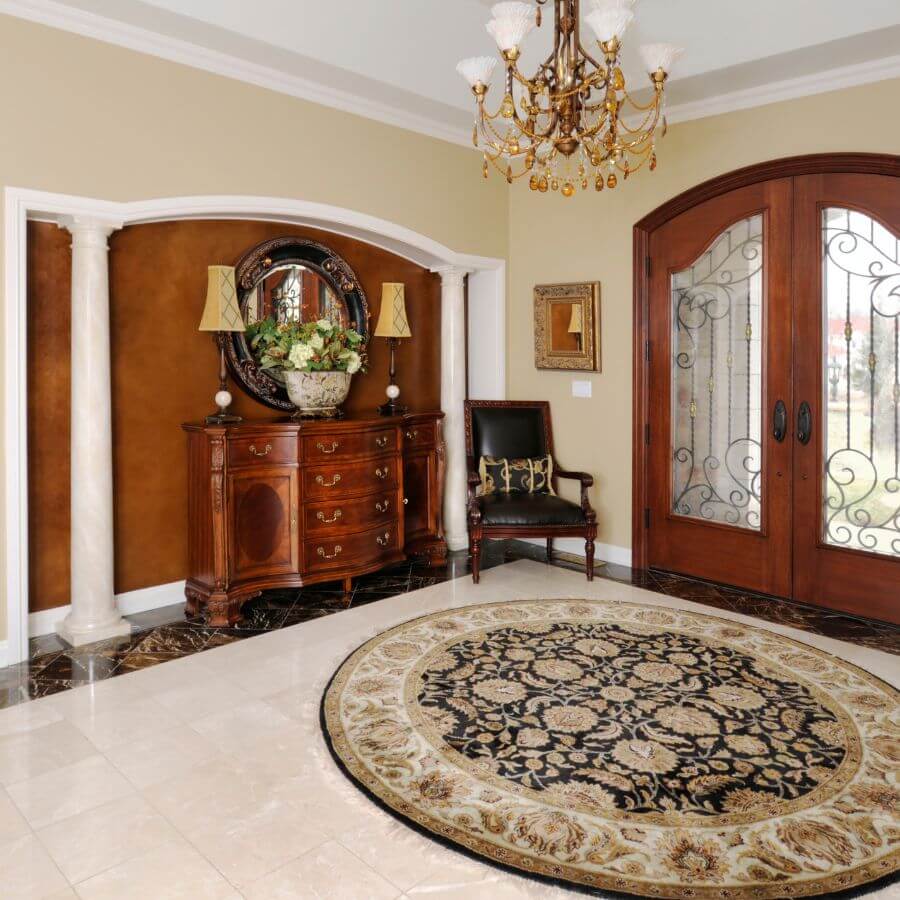 Ivory medallion rug in a grand entrance hall
