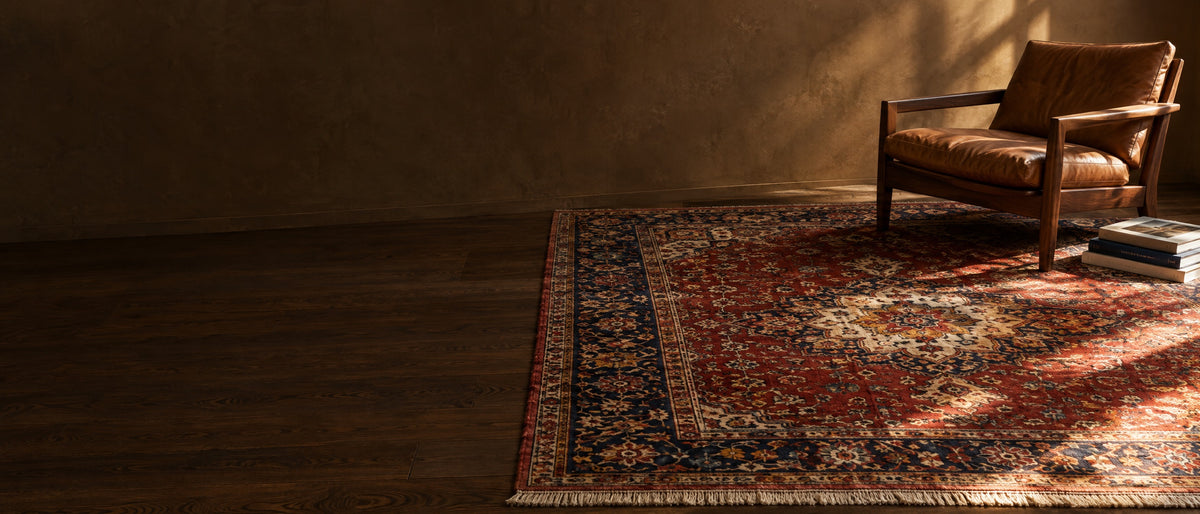 Hand-knotted Persian rug with a leather lounge chair in a warm, sunlit room