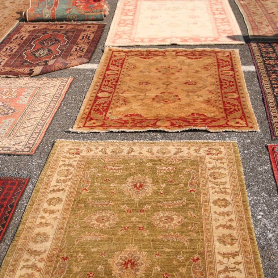 Hand-knotted rugs laid out across the showroom floor